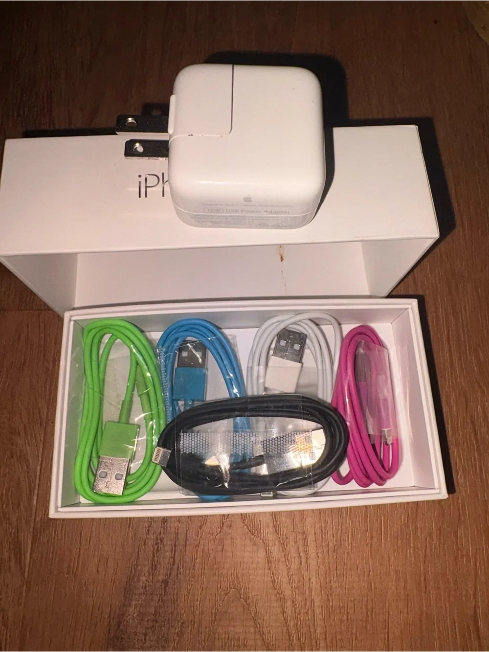 5 collared USB to type A iPhone charging cords and a USB charging block